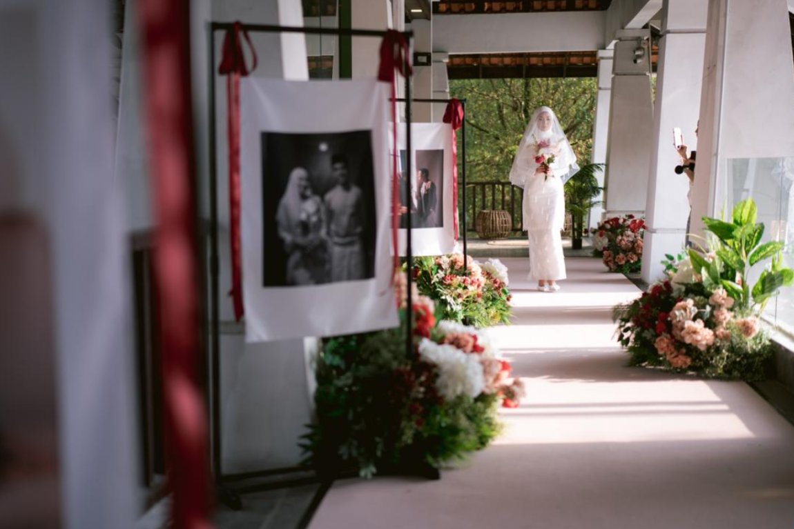 Wedding photo signage along the welcome walkway, dressed with everlasting florals