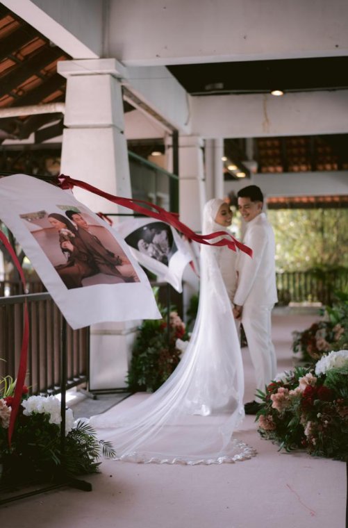 Photo signage beside the bridal floral arch