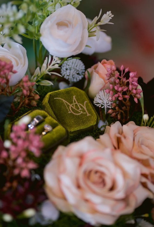 Velvet ring box embroidered with couple's initials, styled with everlasting florals